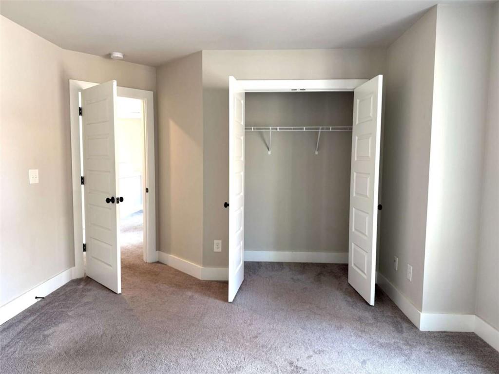 2362 Browns Mill Road Southeast Atlanta, GA 30315 - Photo 36 of 41 an empty room with closet and wooden door