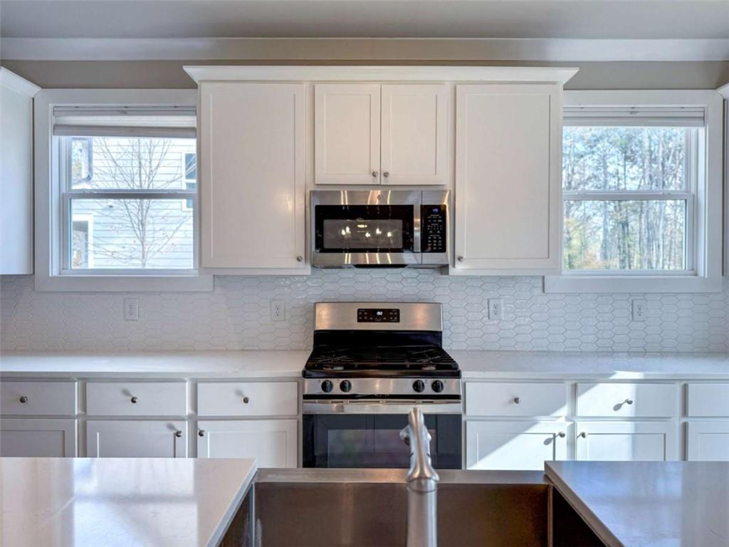 2362 Browns Mill Road Southeast Atlanta, GA 30315 - Photo 7 of 41 a kitchen with cabinets and window