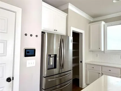 a kitchen with stainless steel appliances and refrigerator