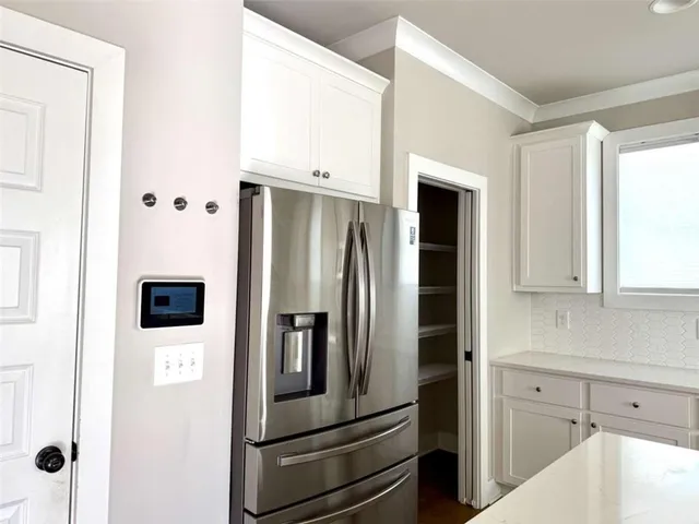 a kitchen with stainless steel appliances and refrigerator