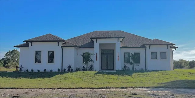 a front view of a house with a yard