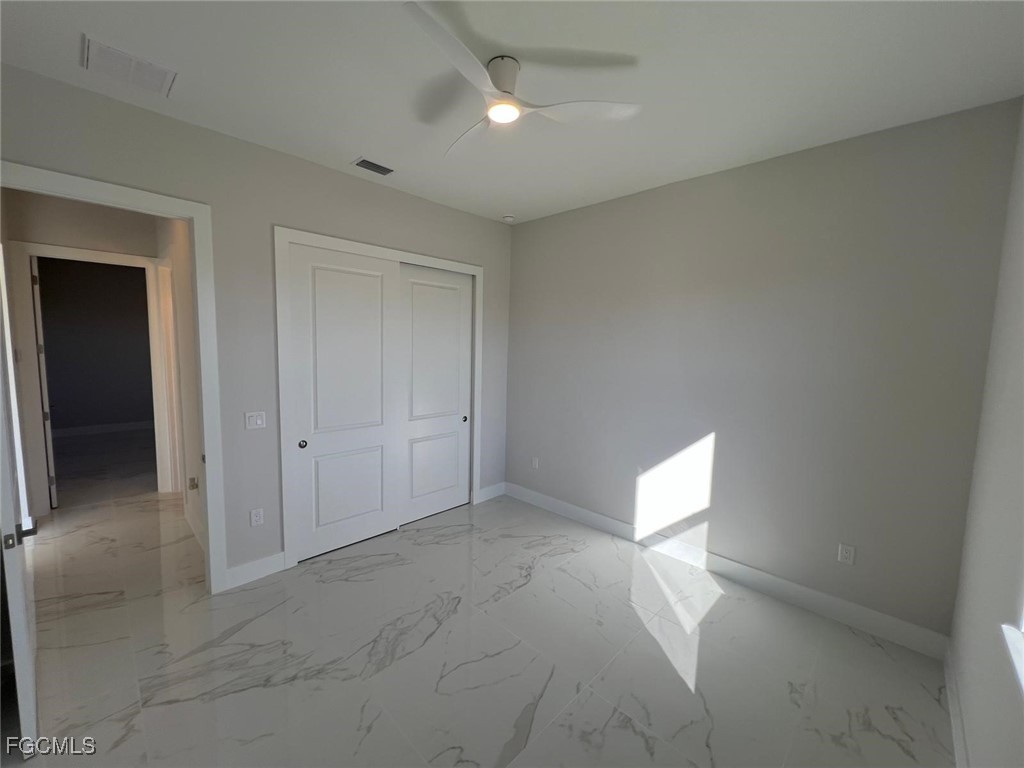 3672 68th Avenue Northeast Naples, FL 34120 - Photo 11 of 18 an empty room with windows and entrance to other room