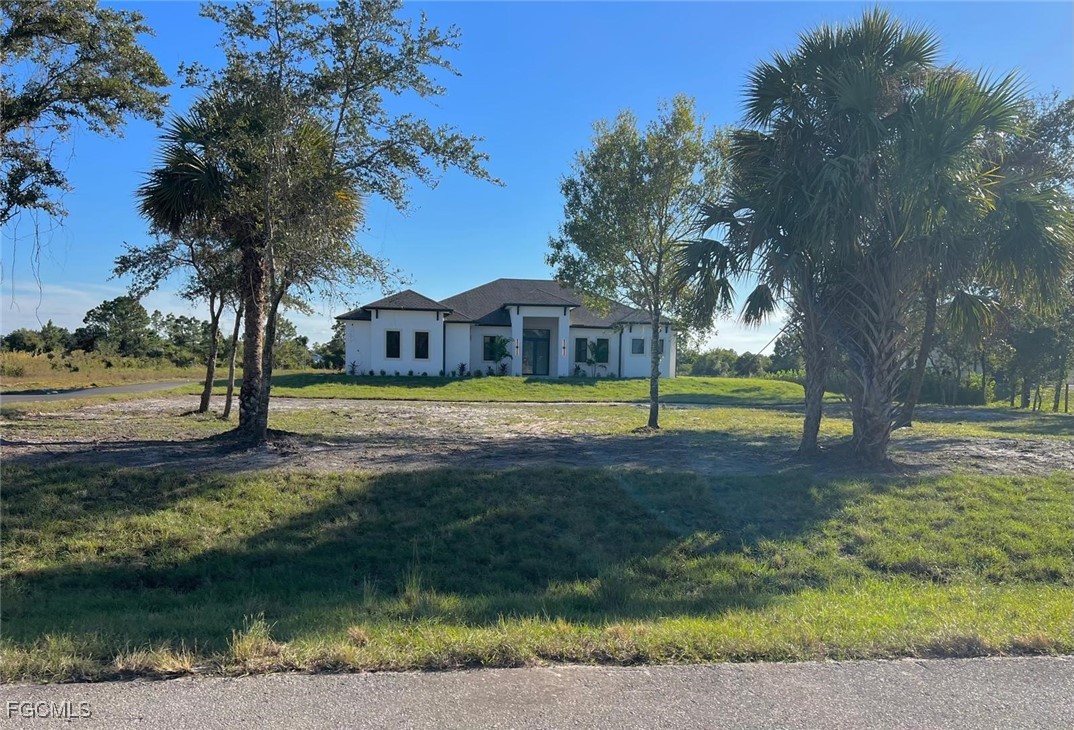 3672 68th Avenue Northeast Naples, FL 34120 - Photo 2 of 18 a view of a house with swimming pool next to a yard