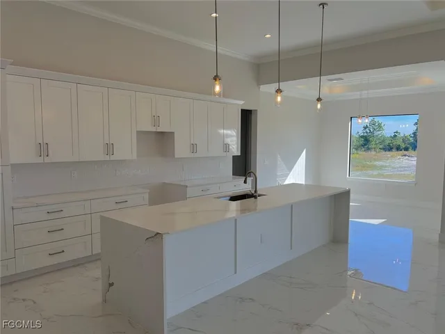 a kitchen with a white wooden cabinets and white appliances