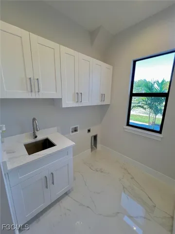 an empty room with windows and entrance to other room