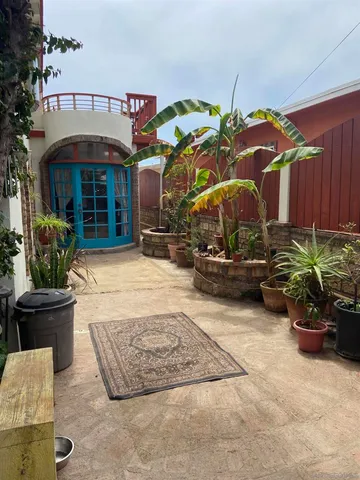 a view of a chair and tables in the patio