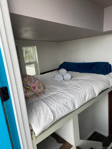 a bedroom with a bed and window