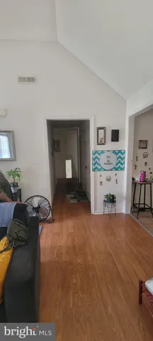 a bedroom with furniture and a wooden floor