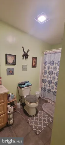 a bathroom with a toilet sink and shower
