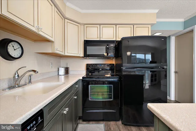 a kitchen with a sink stove and microwave