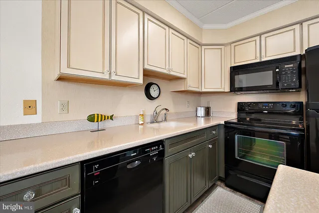 a kitchen with stainless steel appliances granite countertop a sink dishwasher a stove microwave and cabinets