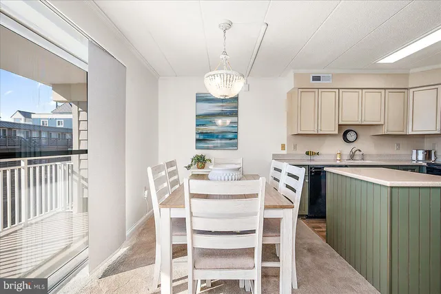 a kitchen with a dining table chairs sink and stove
