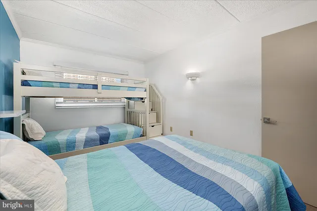 a bedroom with a bed and chair