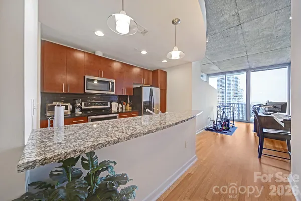 a large kitchen with lots of counter space and stainless steel appliances
