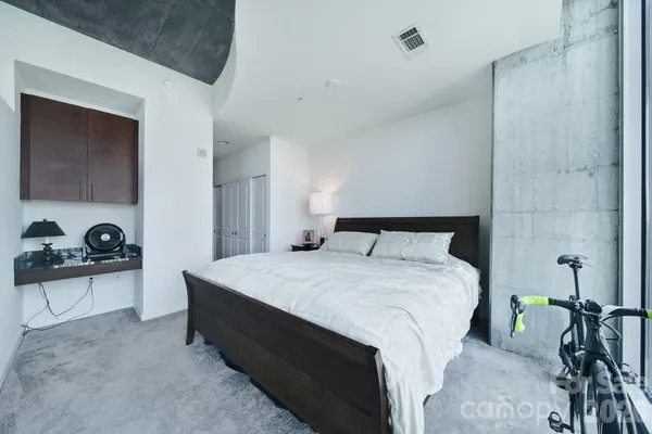 a spacious bedroom with a bed and a table in it