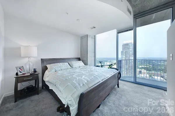 a bedroom with a large bed and a large window
