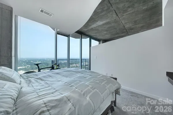 a bed sitting in a bedroom next to a window