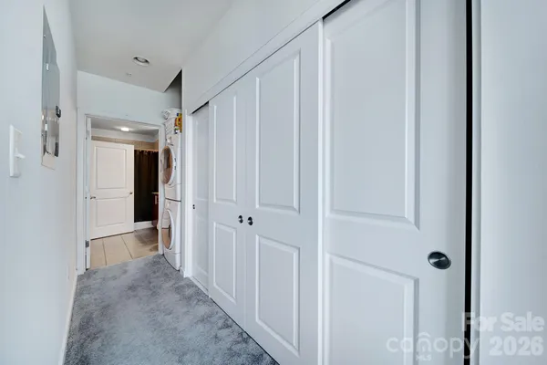 a view of a hallway with wooden shelves