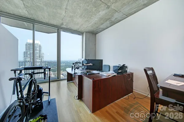 a view of a workspace with furniture and a table