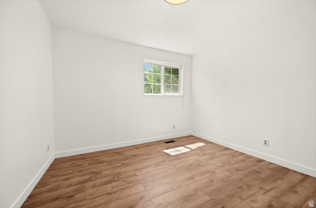 2163 Borg Drive Sandy, UT 84092 - Photo 17 of 31 Unfurnished room featuring wood finished floors and baseboards