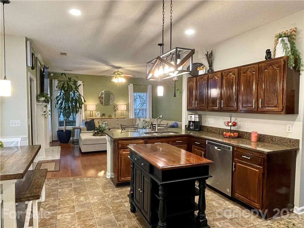 6607 Reedy Creek Road Charlotte, NC 28215 - Photo 12 of 27 a kitchen with kitchen island a sink stove and cabinets