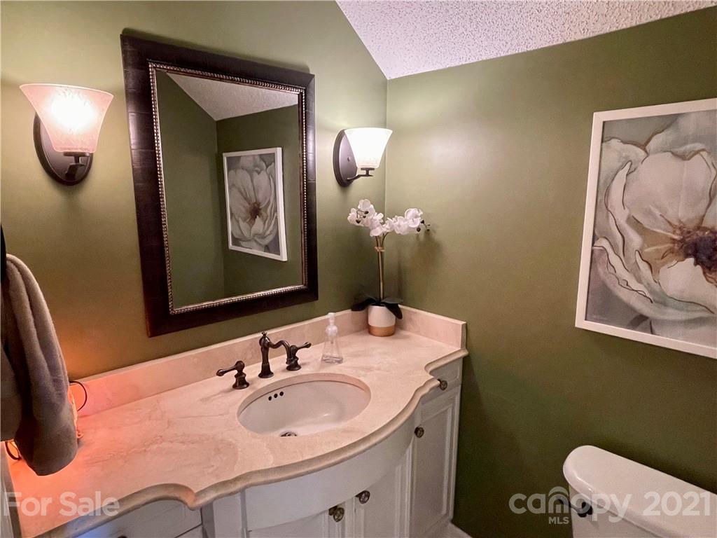 6607 Reedy Creek Road Charlotte, NC 28215 - Photo 15 of 27 a bathroom with a sink and mirror with toilet