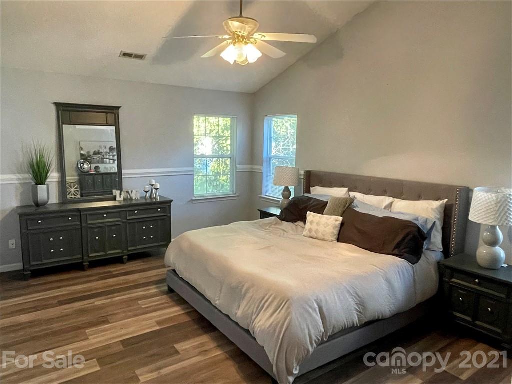 6607 Reedy Creek Road Charlotte, NC 28215 - Photo 17 of 27 a bedroom with a bed and a dresser