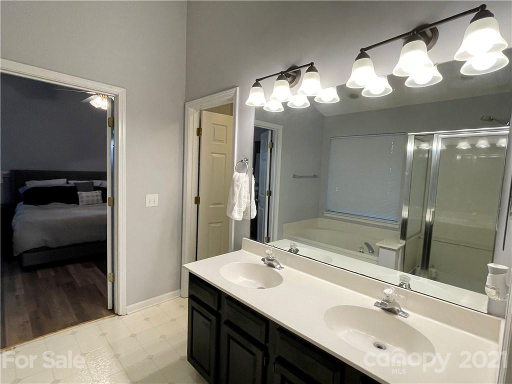6607 Reedy Creek Road Charlotte, NC 28215 - Photo 18 of 27 a bathroom with a sink double vanity and a mirror