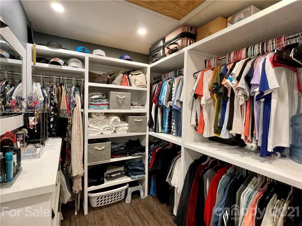 6607 Reedy Creek Road Charlotte, NC 28215 - Photo 19 of 27 a view of walk in closet with clothes and shoes