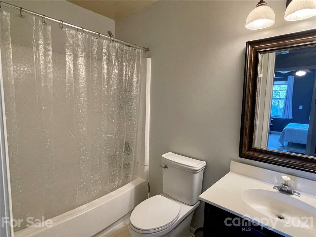 6607 Reedy Creek Road Charlotte, NC 28215 - Photo 22 of 27 a bathroom with a sink a toilet and shower