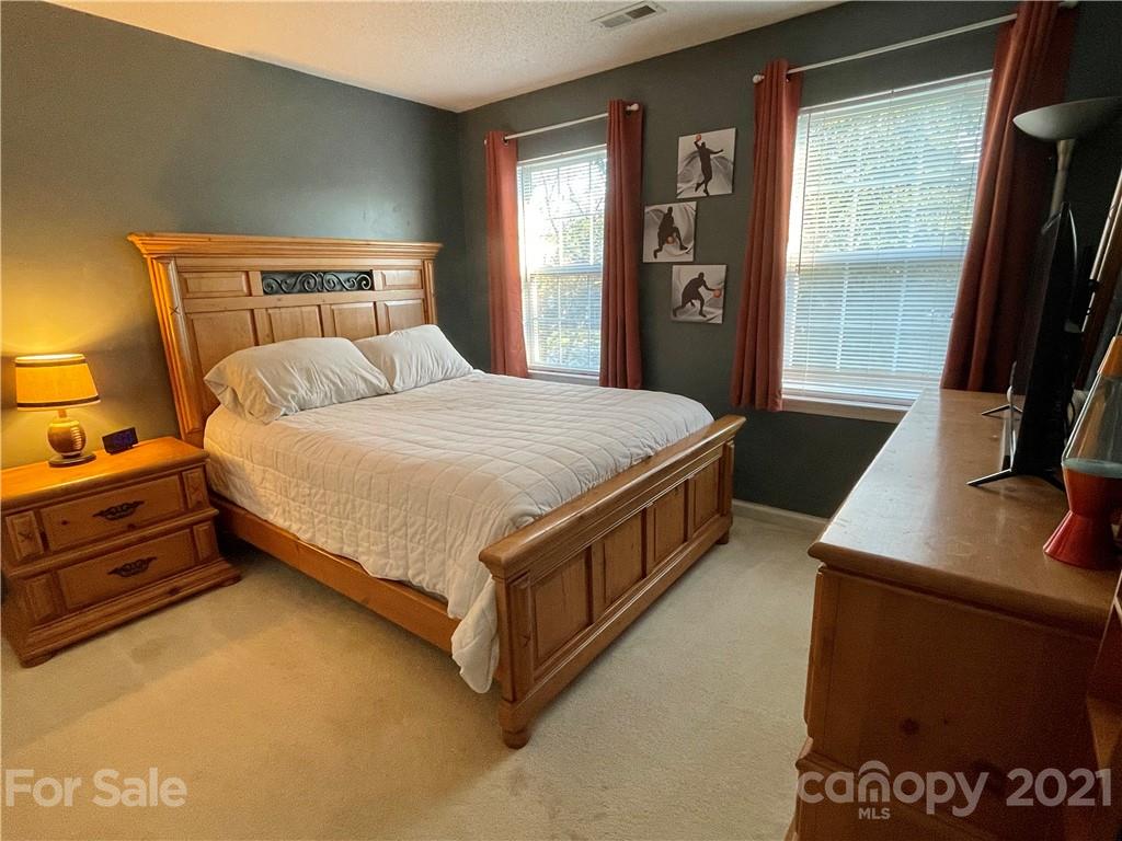 6607 Reedy Creek Road Charlotte, NC 28215 - Photo 24 of 27 a bed sitting in a bedroom next to a window
