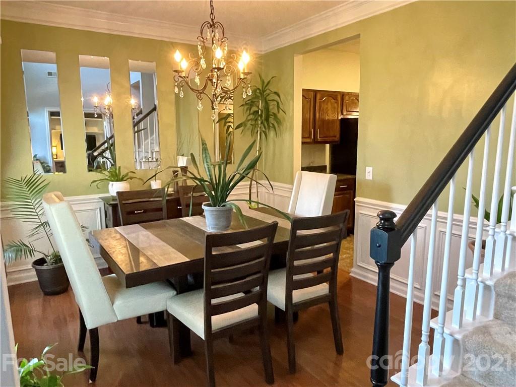 6607 Reedy Creek Road Charlotte, NC 28215 - Photo 7 of 27 a view of a dining room with furniture and wooden floor