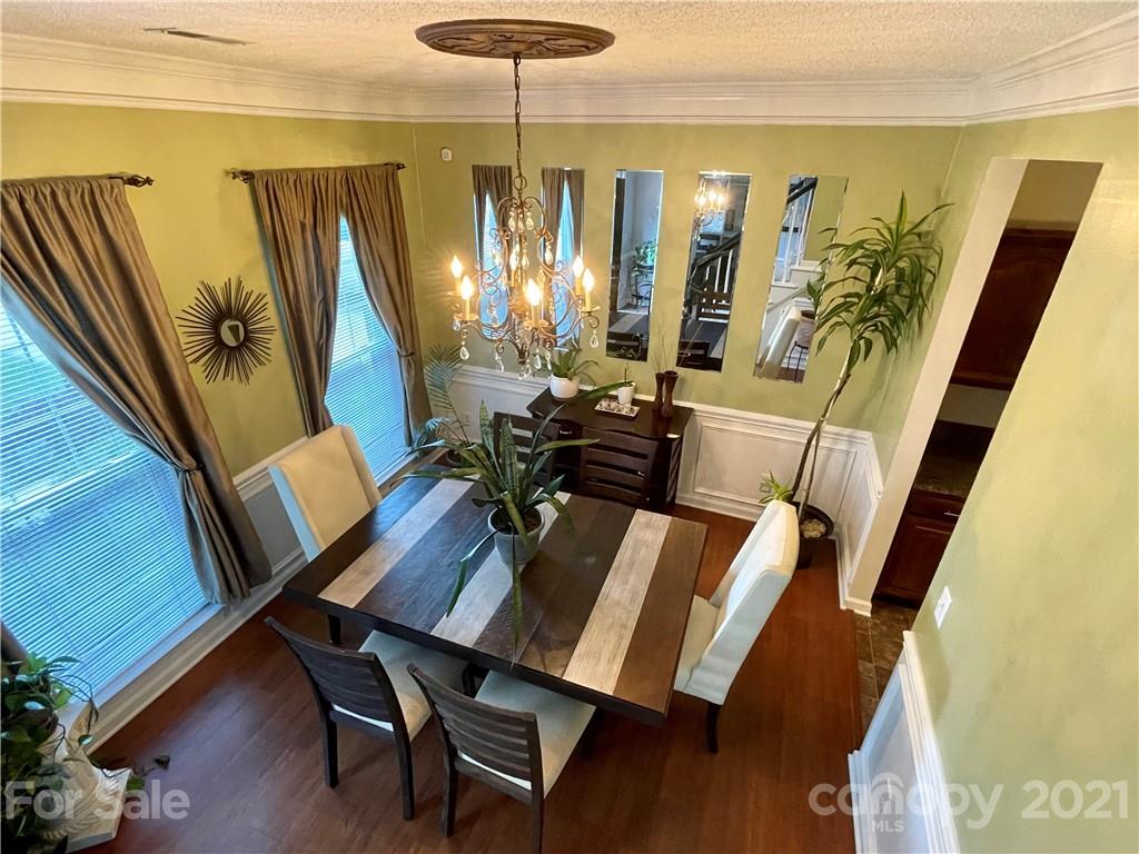 6607 Reedy Creek Road Charlotte, NC 28215 - Photo 8 of 27 a view of a dining room with furniture window and wooden floor