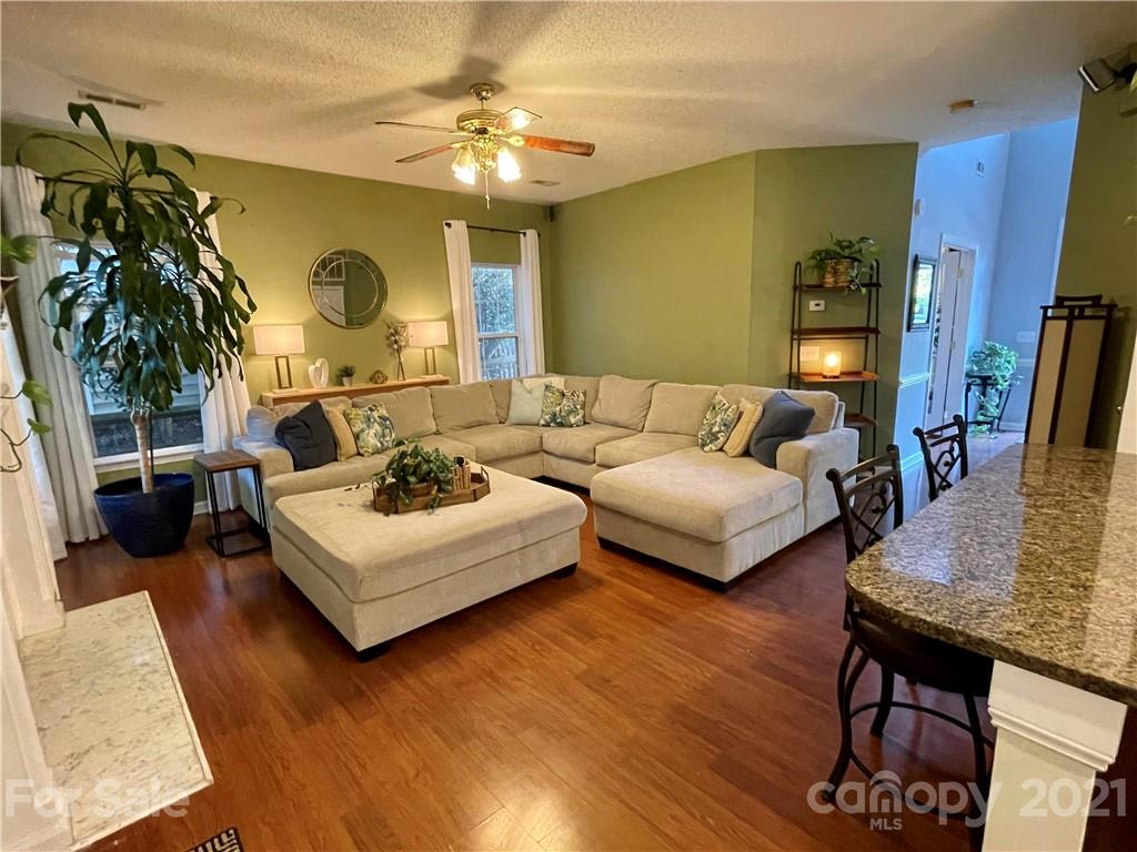 6607 Reedy Creek Road Charlotte, NC 28215 - Photo 10 of 27 a living room with furniture and wooden floor