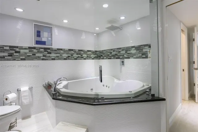a bathroom with a double vanity sink toilet and a mirror