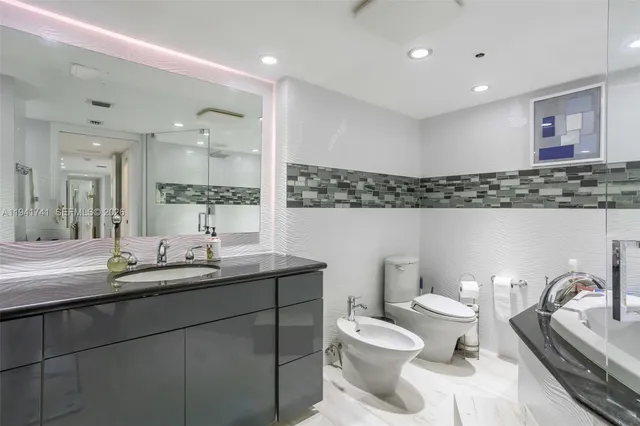 a kitchen with stainless steel appliances kitchen island granite countertop a refrigerator and sink