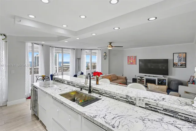 a kitchen with stainless steel appliances granite countertop a sink and a stove