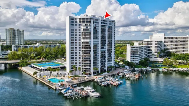 an aerial view of a house with swimming pool and outdoor seating