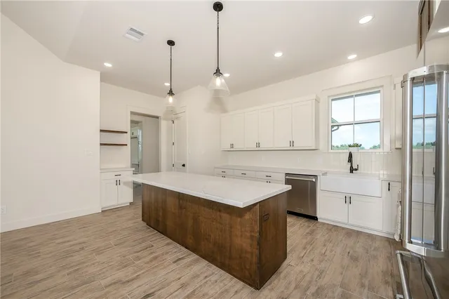 a kitchen with a sink stove and refrigerator