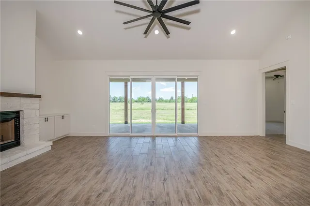 a large white kitchen with a sink stainless steel appliances and cabinets