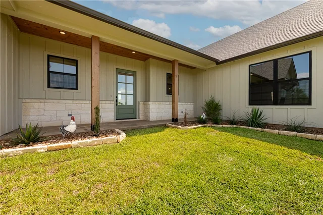 a house with swimming pool in front of it