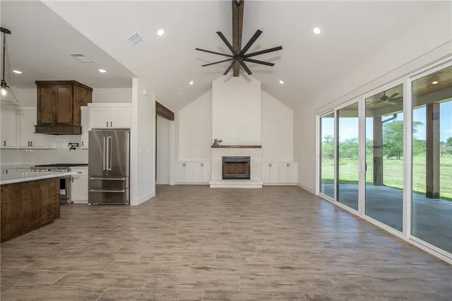 a view of a kitchen with a sink and a fireplace