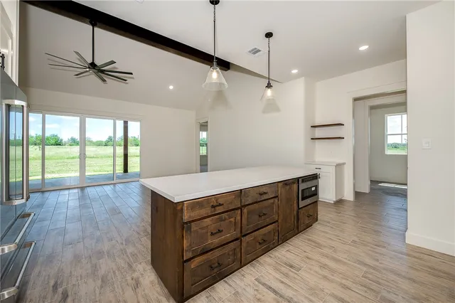 a kitchen with a wooden floor and window
