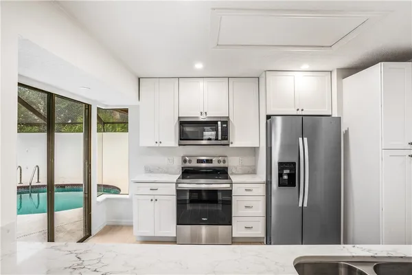 a kitchen with a refrigerator a stove and a sink