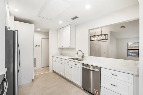 a kitchen with a sink stove and refrigerator