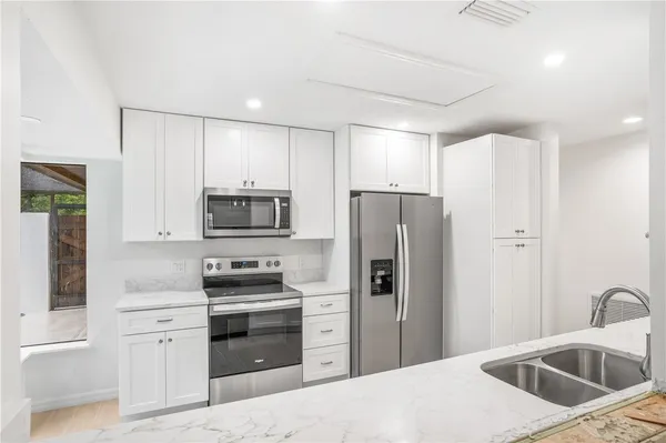 a kitchen with a refrigerator sink and microwave