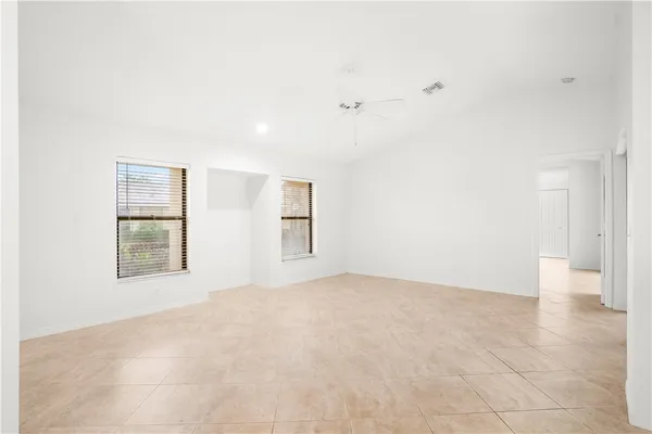 an empty room with windows and closet