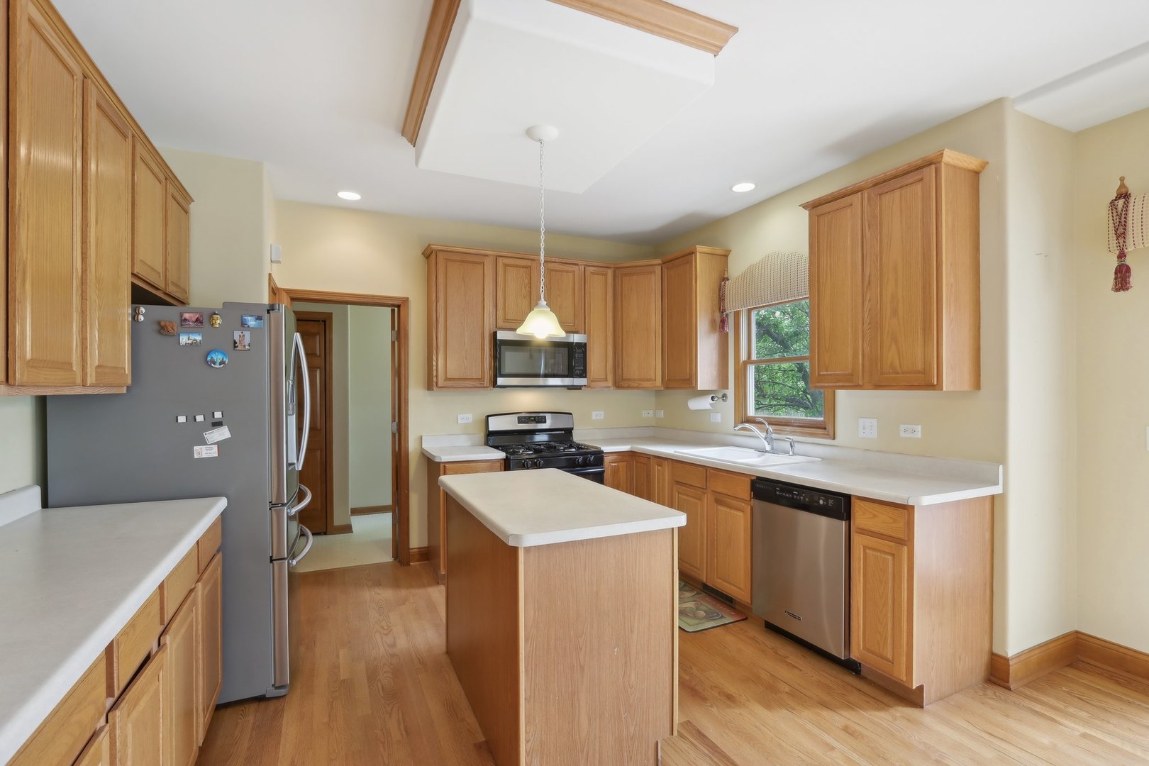548 Asbury Drive Aurora, IL 60502 - Photo 14 of 48 a kitchen with a stove a sink and a refrigerator