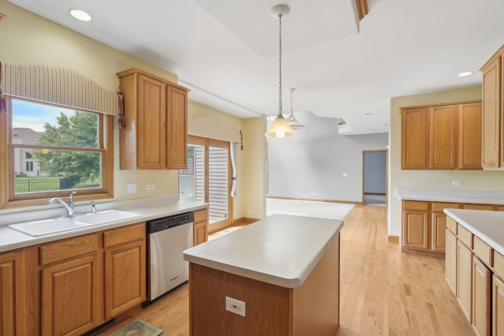 548 Asbury Drive Aurora, IL 60502 - Photo 15 of 48 a kitchen with a sink a center island and a window