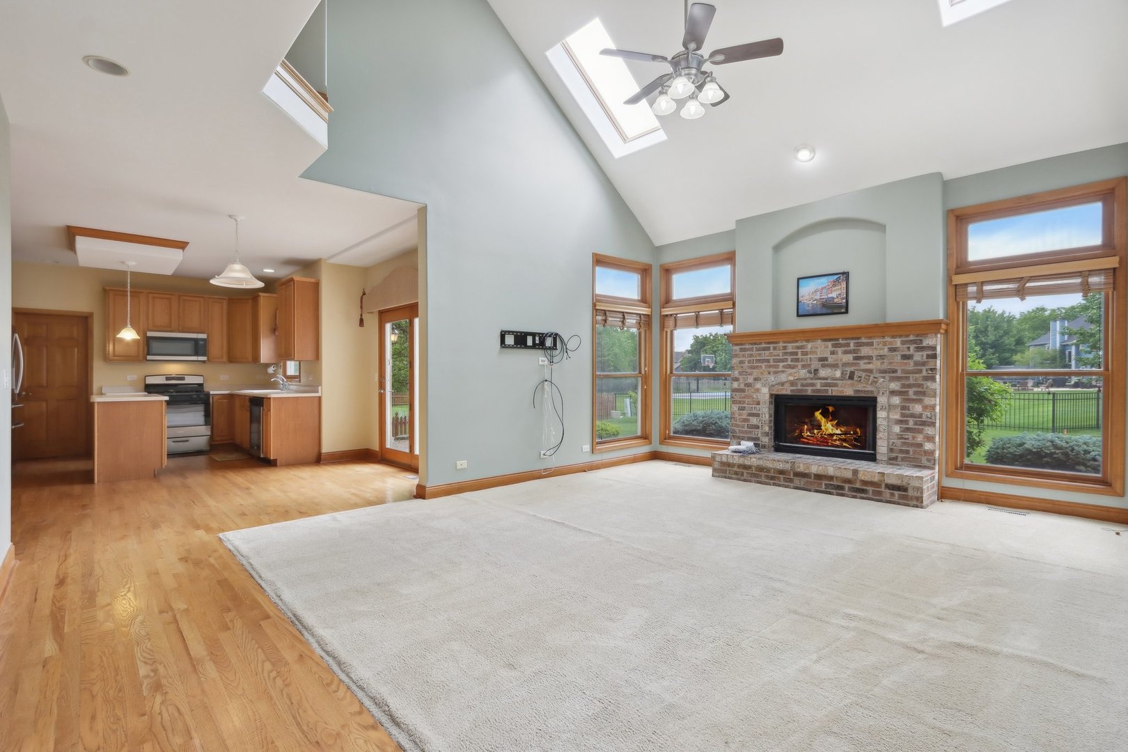 548 Asbury Drive Aurora, IL 60502 - Photo 17 of 48 a view of an empty room with a fireplace and a window